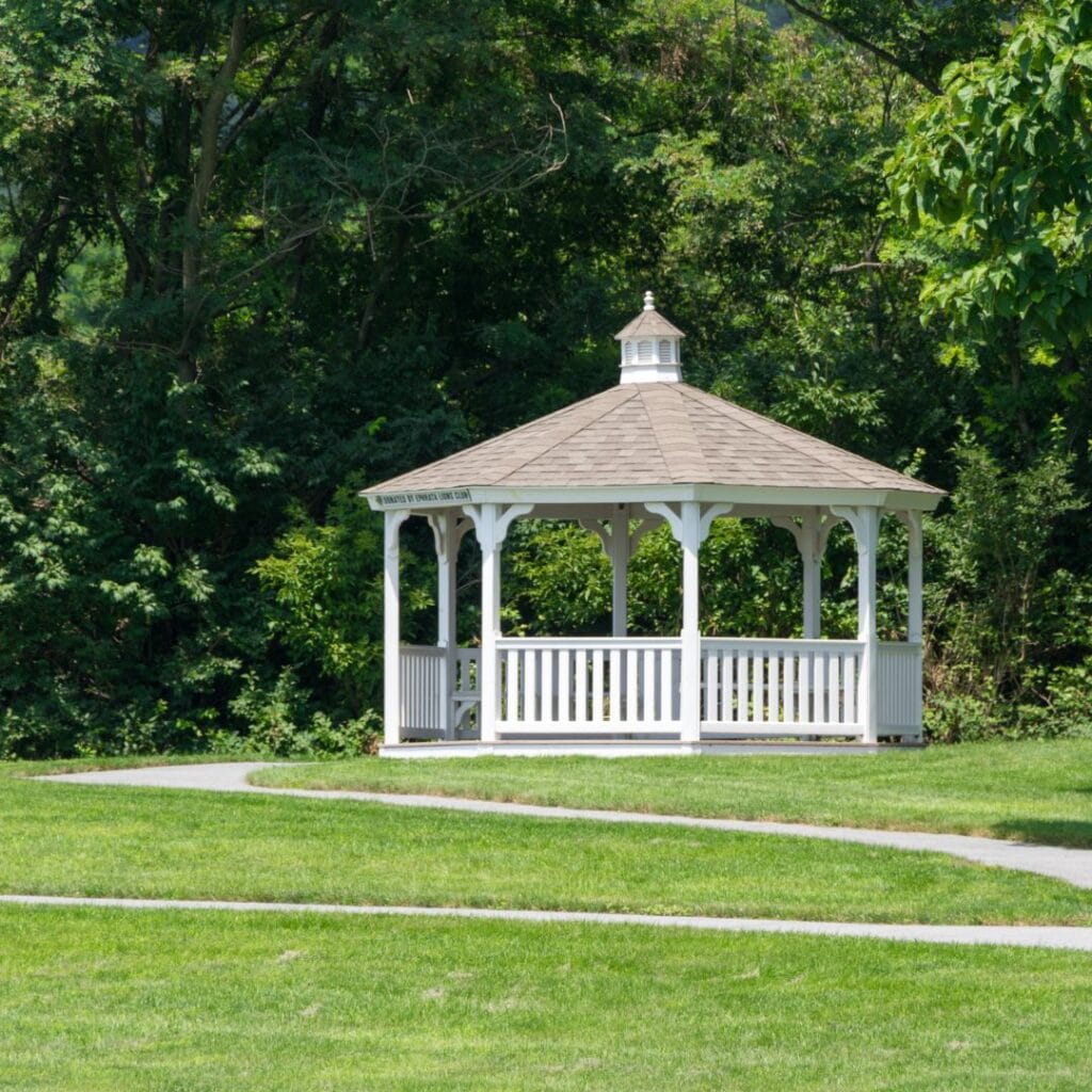 White gazebo outdoor living space built in backyard of house near Helena, Alabama.