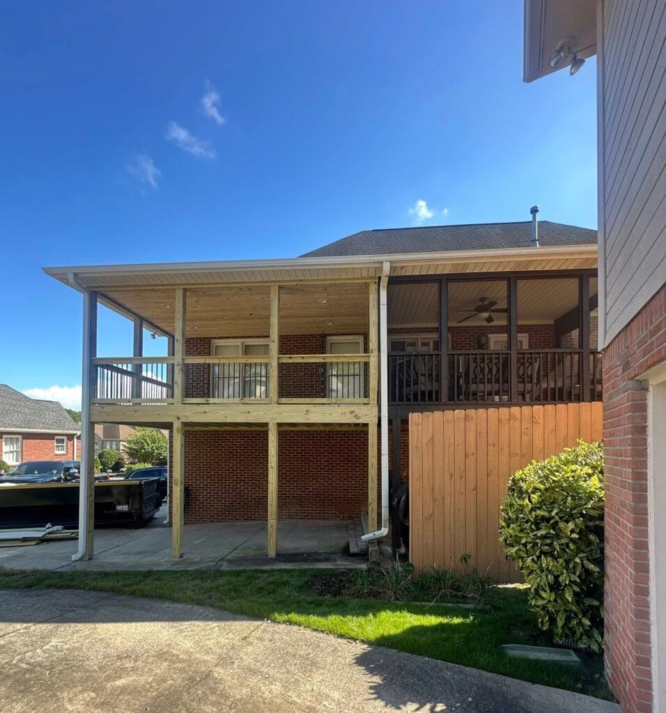 Gutter installation on newly covered backyard deck in Meadowbrook, AL, protecting outdoor living space from rainwater and improving drainage around roofed patio structure