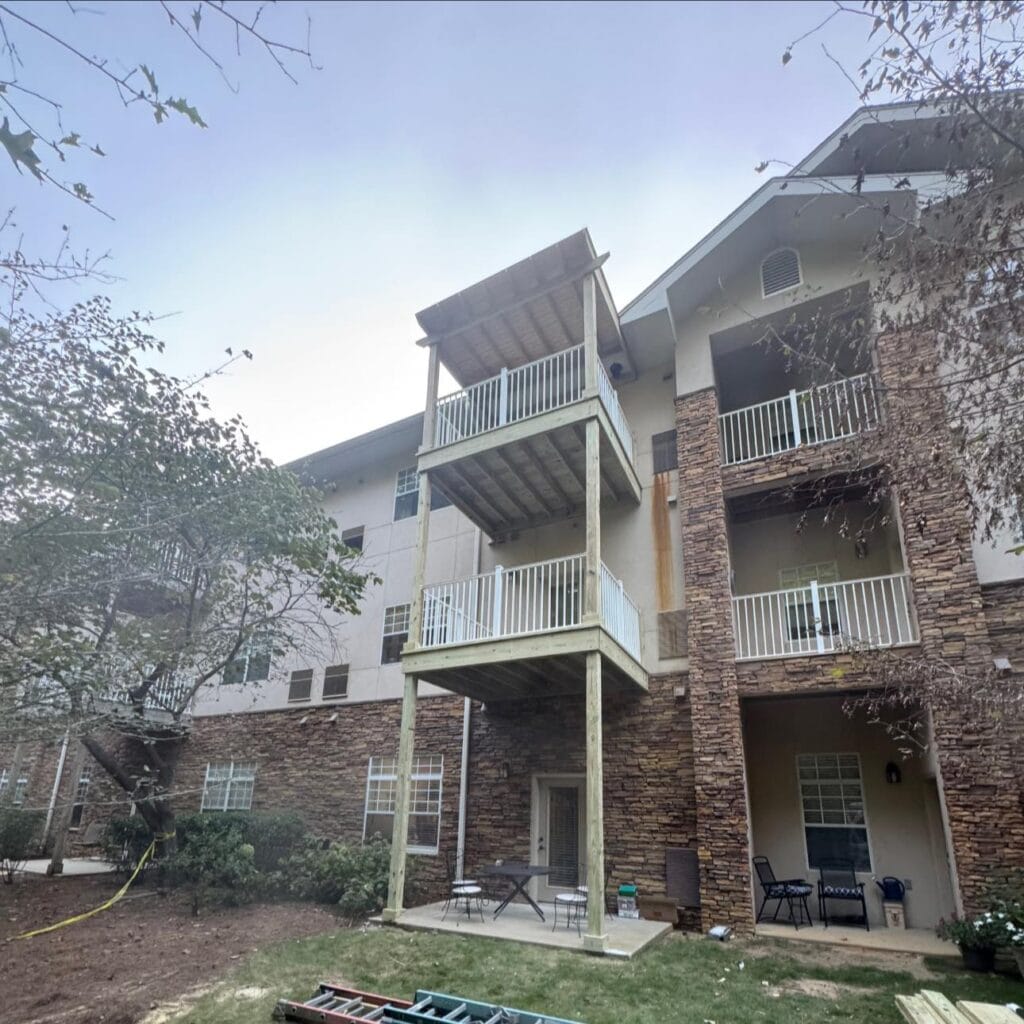 Porch construction project at Somerby St. Vincent’s Senior Living replacing an old three-story rotted deck with a newly rebuilt covered porch.