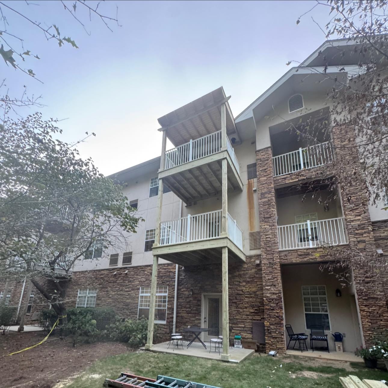 Porch construction project at Somerby St. Vincent’s Senior Living replacing an old three-story rotted deck with a newly rebuilt covered porch.