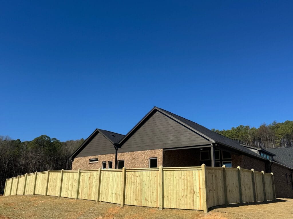 Six-foot Hampton-style privacy fence installation in Hoover, AL, enclosing a backyard, providing full privacy with a clean, classic design.